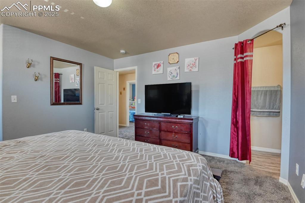 Image 28 of 43: Bedroom featuring carpet flooring and a textured ceiling