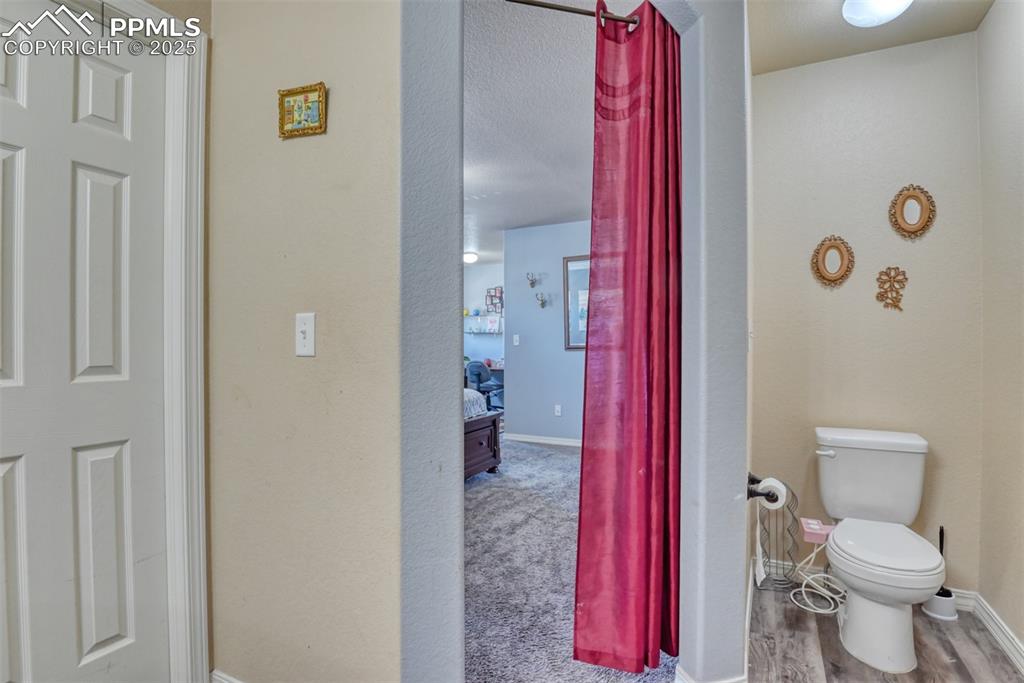 Image 33 of 43: Bathroom with toilet and wood finished floors