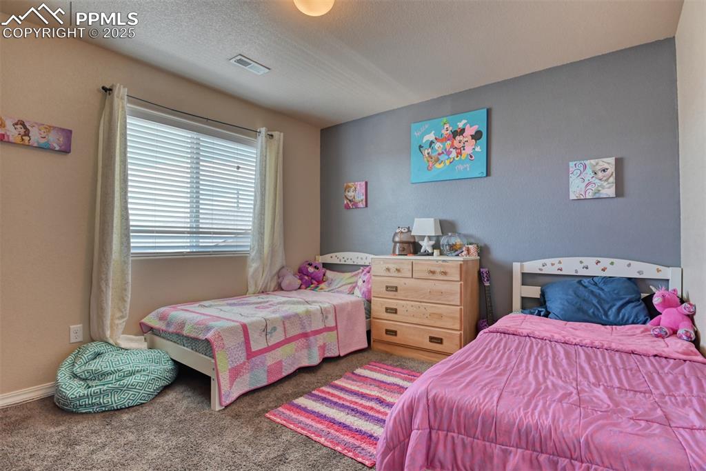 Image 34 of 43: Bedroom with carpet floors and baseboards