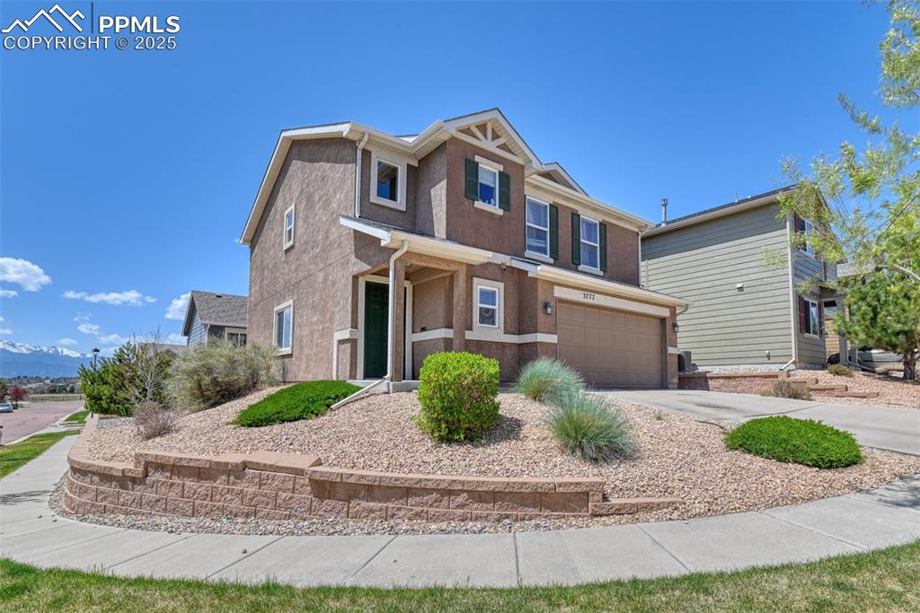 Image 4 of 43: View of front of house featuring an attached garage, driveway, and stucco s