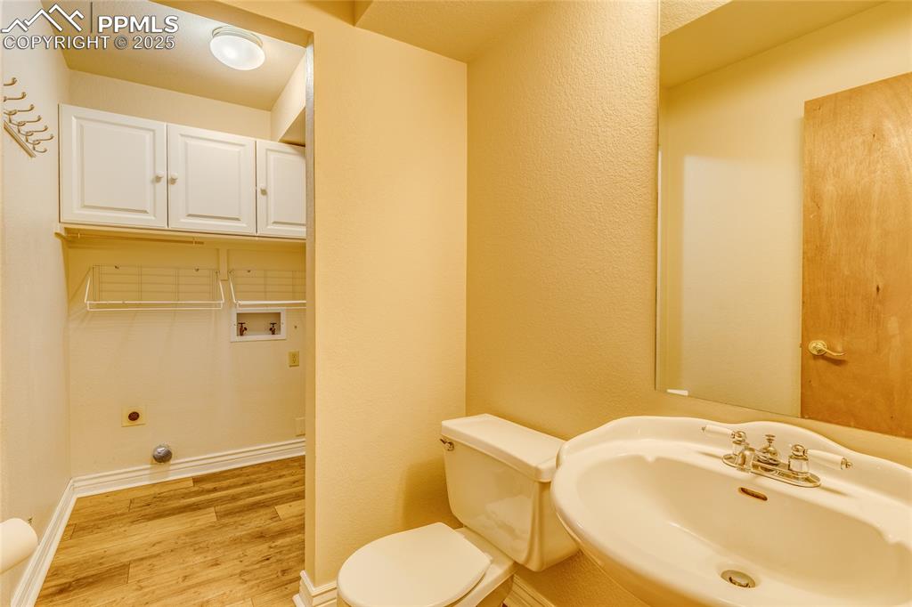 Image 14 of 46: Main level 1/2 bath and laundry room