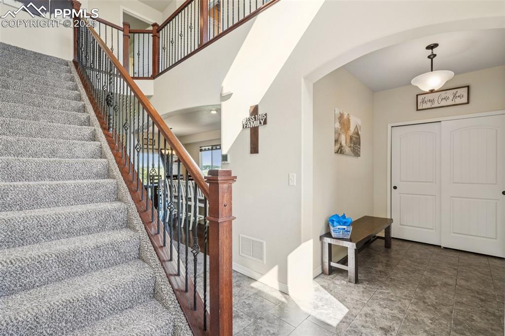 Image 17 of 46: Stairs with arched walkways and baseboards