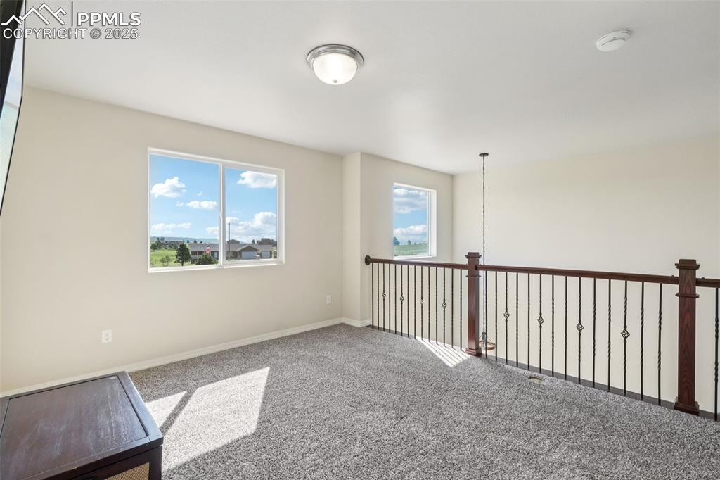 Image 18 of 46: Empty room with carpet flooring and a smoke detector