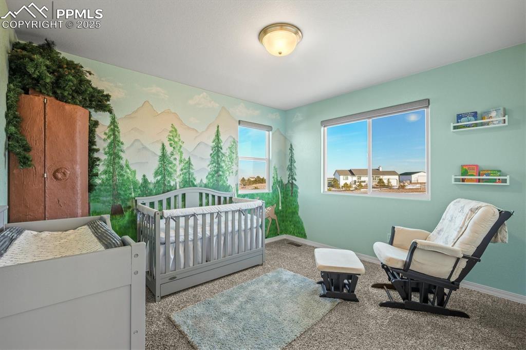 Image 26 of 46: Bedroom with a nursery area, carpet flooring, and baseboards