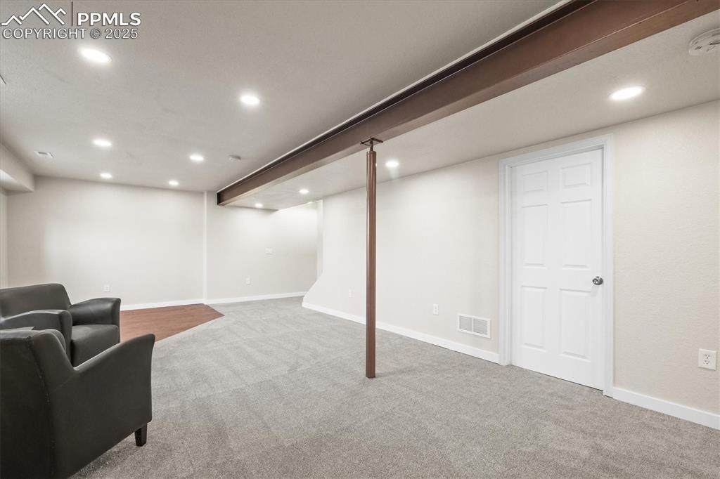 Image 31 of 46: Finished basement with recessed lighting, carpet flooring, visible vents, a