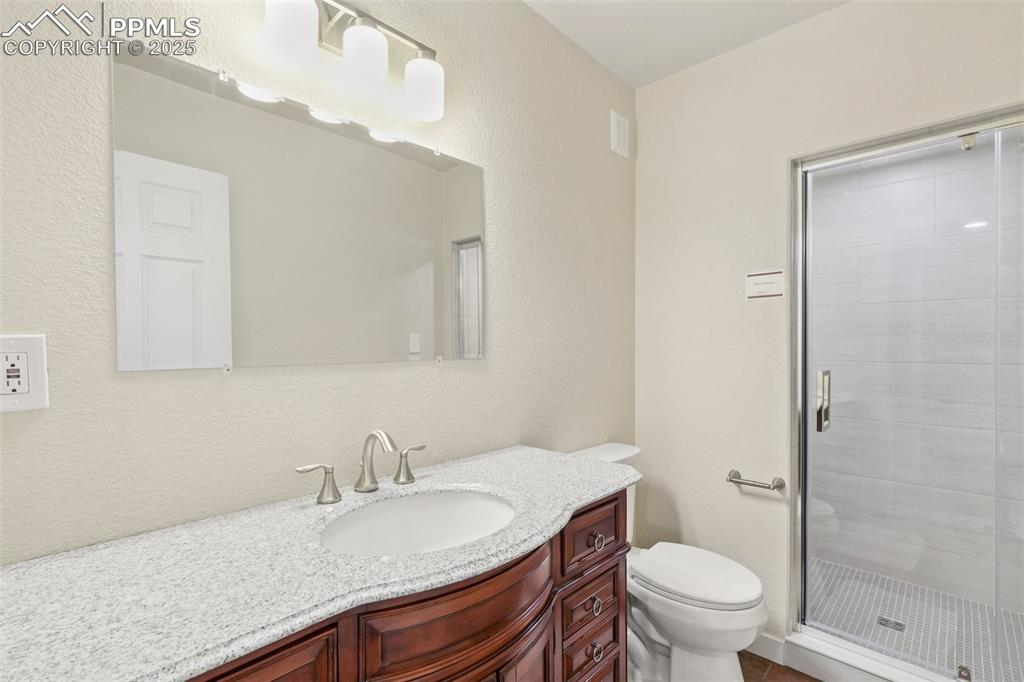 Image 33 of 46: Full bathroom featuring vanity and a shower stall