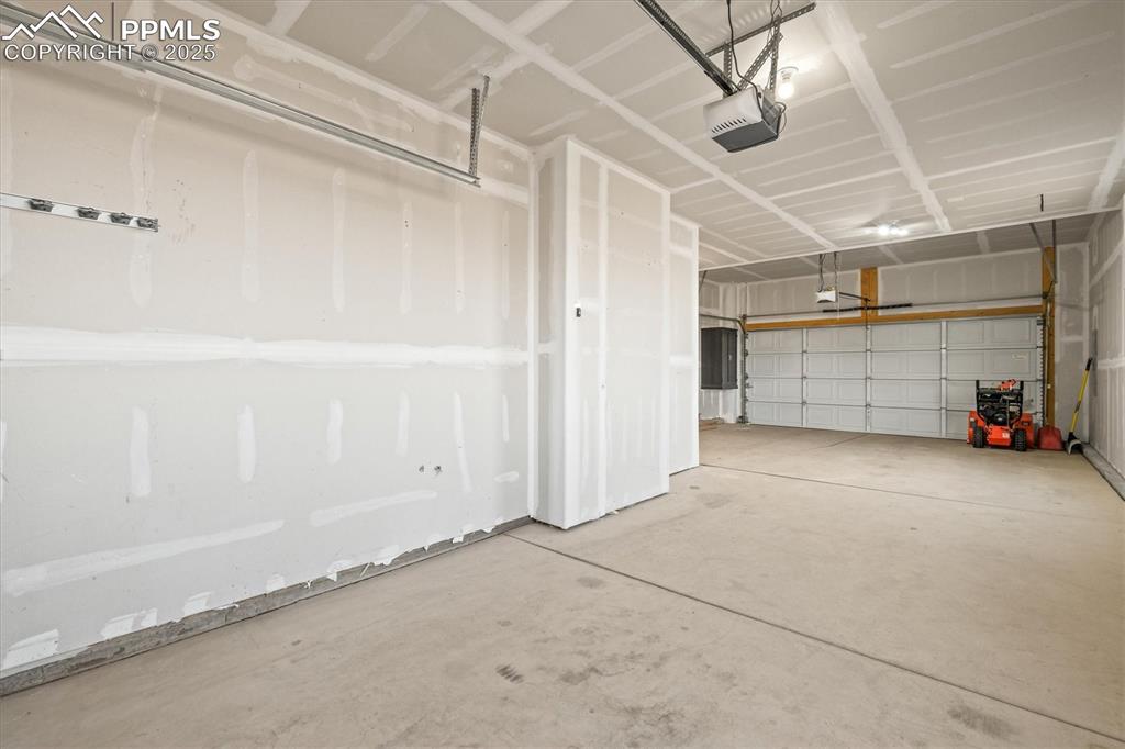 Image 37 of 46: Garage featuring a garage door opener