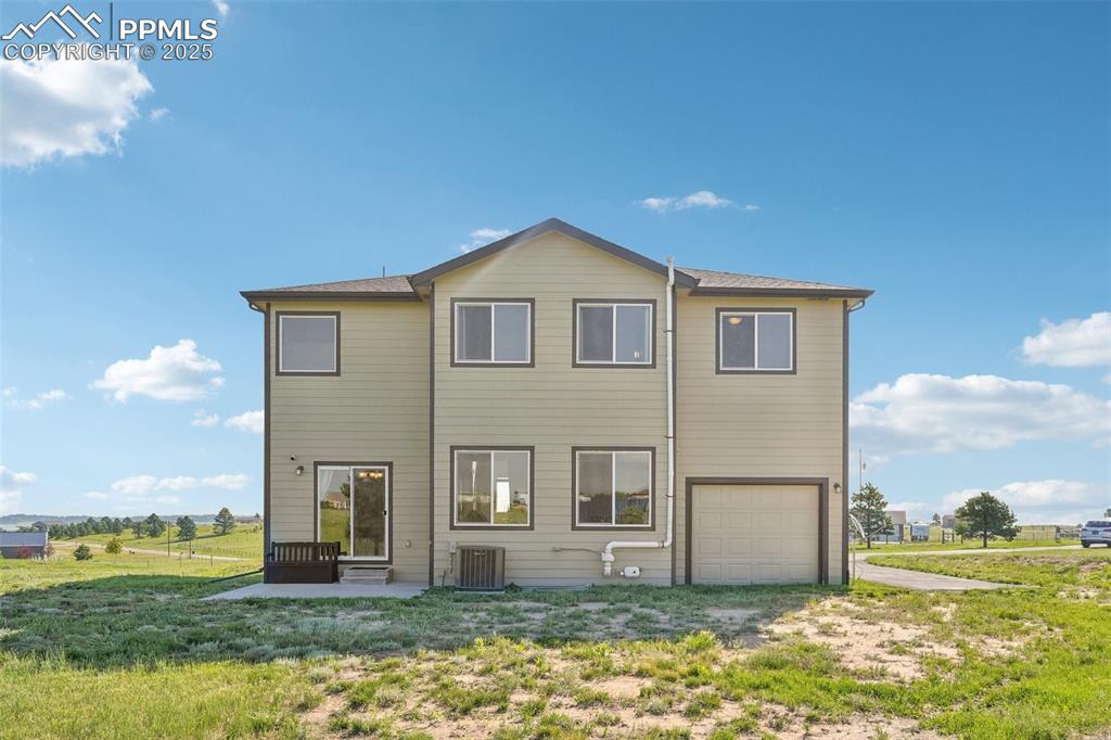 Image 40 of 46: Rear view of property with an attached garage and driveway