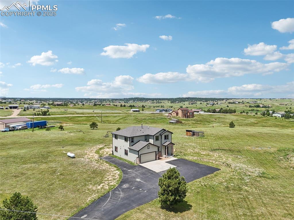 Image 43 of 46: Aerial view of sparsely populated area featuring agricultural land