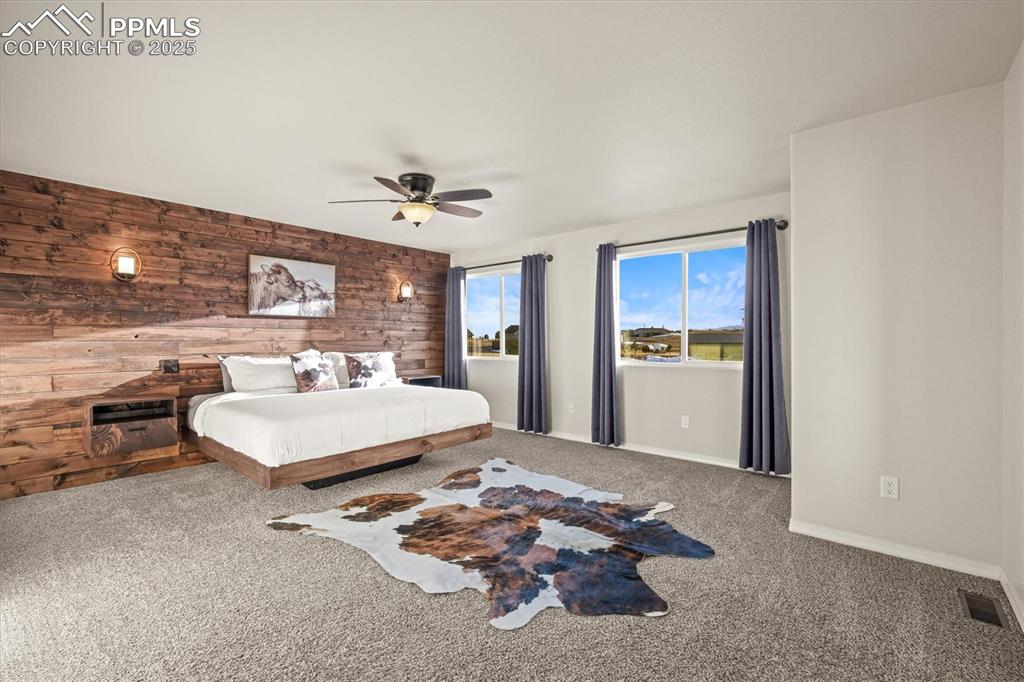 Image 5 of 46: Bedroom with visible vents, baseboards, a ceiling fan, carpet flooring, and