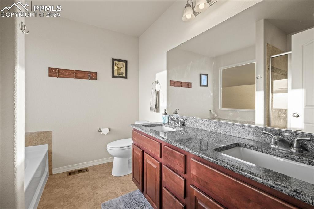 Image 6 of 46: Full bathroom featuring a stall shower, visible vents, a sink, and toilet