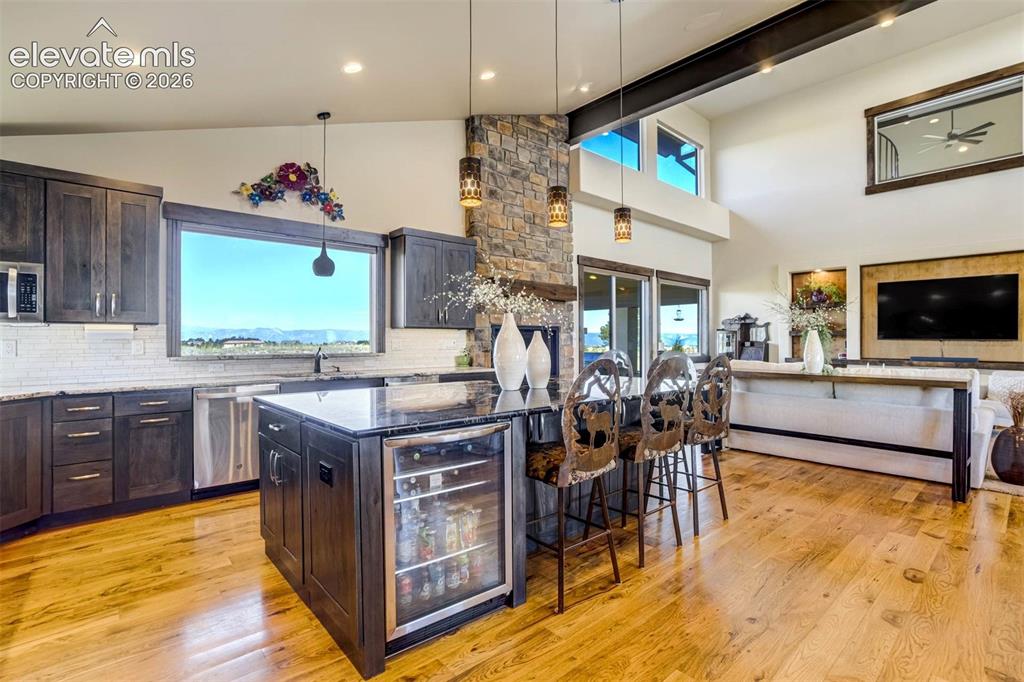 Image 17 of 50: Gourmet kitchen with oversized island and beverage center
