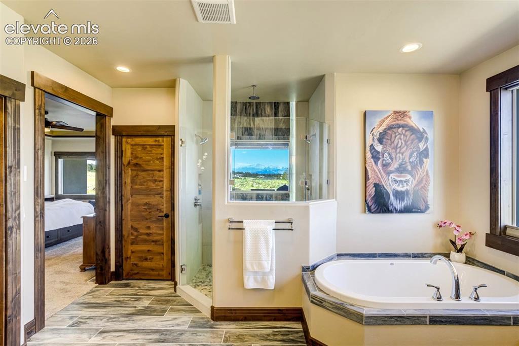 Image 29 of 50: Master Bath features dual vanities, luxurious shower, soaking tub, separate