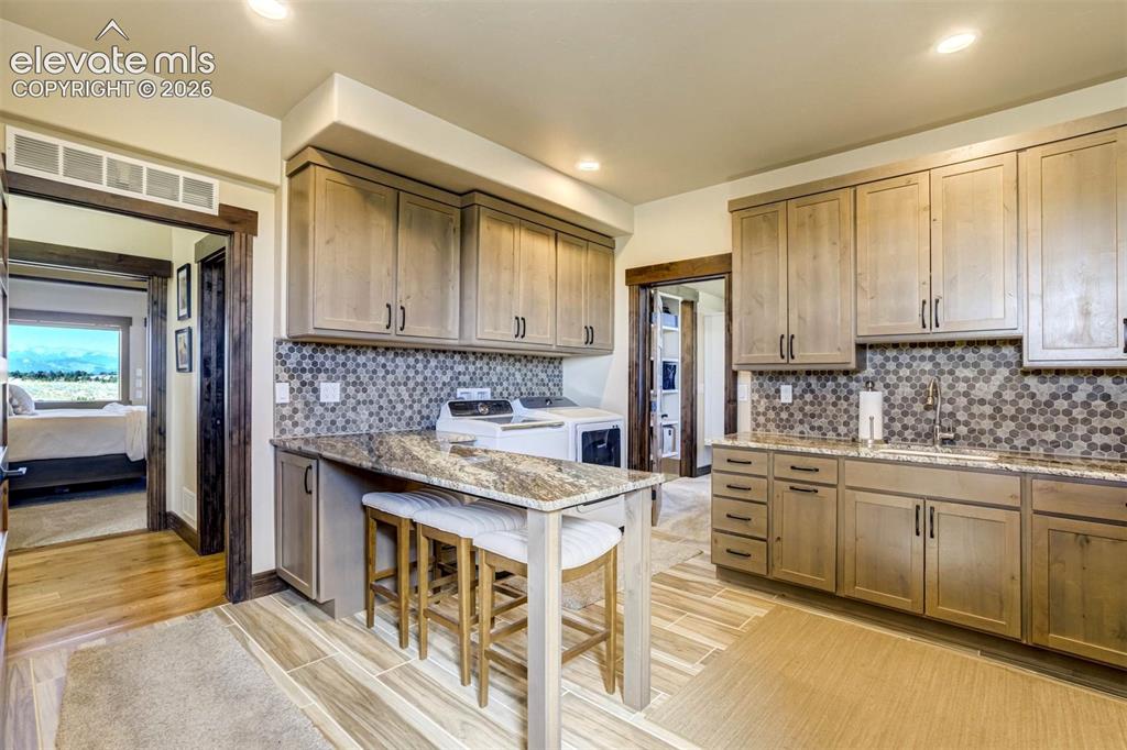 Image 30 of 50: Laundry/Mudroom with direct access to master closet and garage