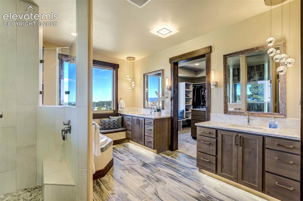 Image 9 of 50: Master Bath features dual vanities, luxurious shower, soaking tub, separate