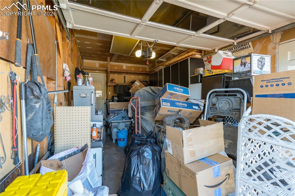Image 37 of 42: garage with workbench and cabinetry