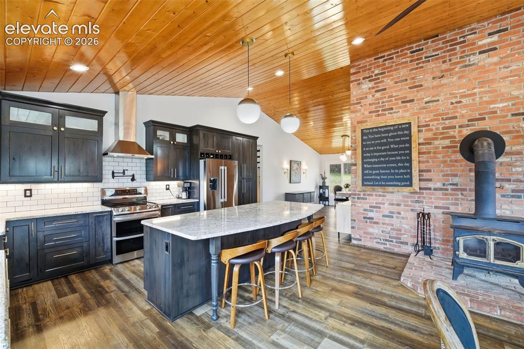 Image 11 of 50: Perfect flow from kitchen/dining to deck for entertaining