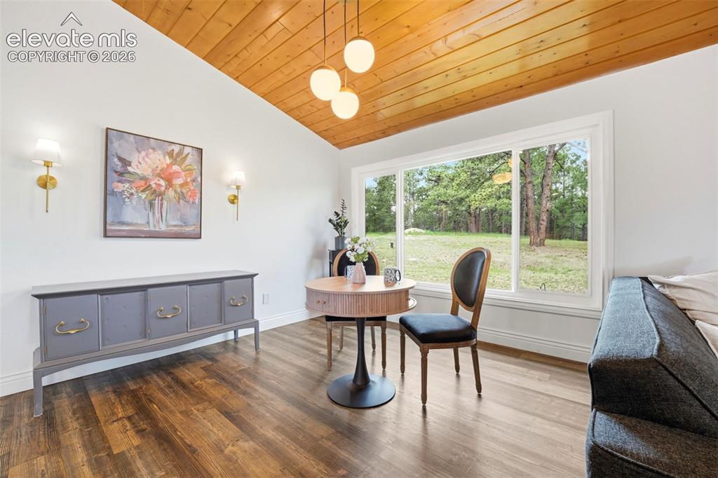 Image 16 of 50: Warm living area with a brick hearth