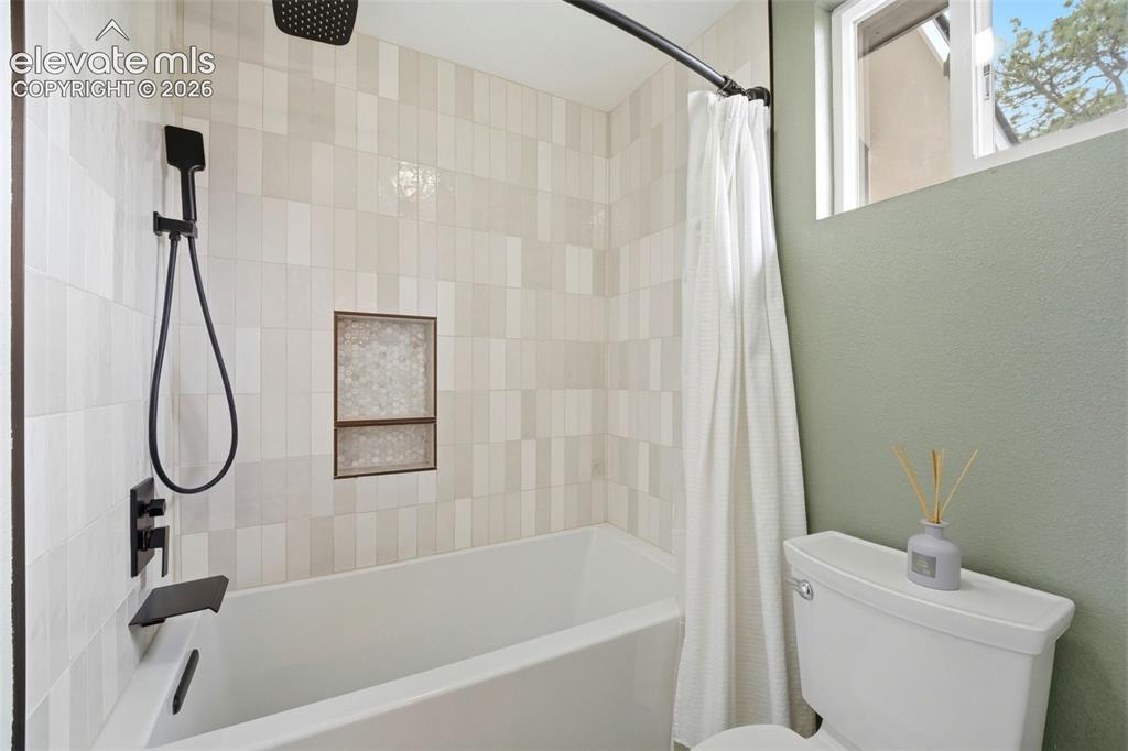 Image 26 of 50: Updated primary bath offers dual vanities and custom cabinets