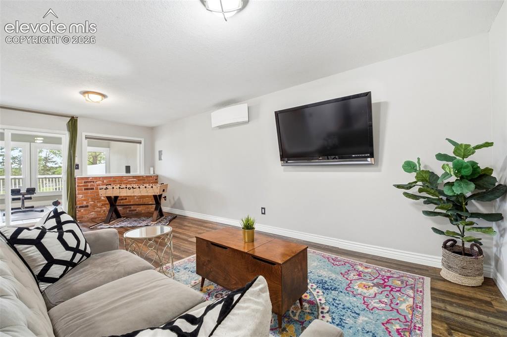 Image 33 of 50: Spacious second upper bedroom with a built-in bookshelf and ceiling fan