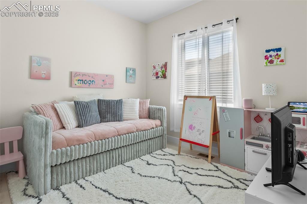 Image 25 of 48: Living room with baseboards and wood finished floors