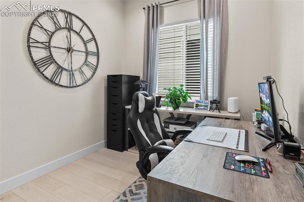 Image 28 of 48: Office with light wood-style flooring and baseboards