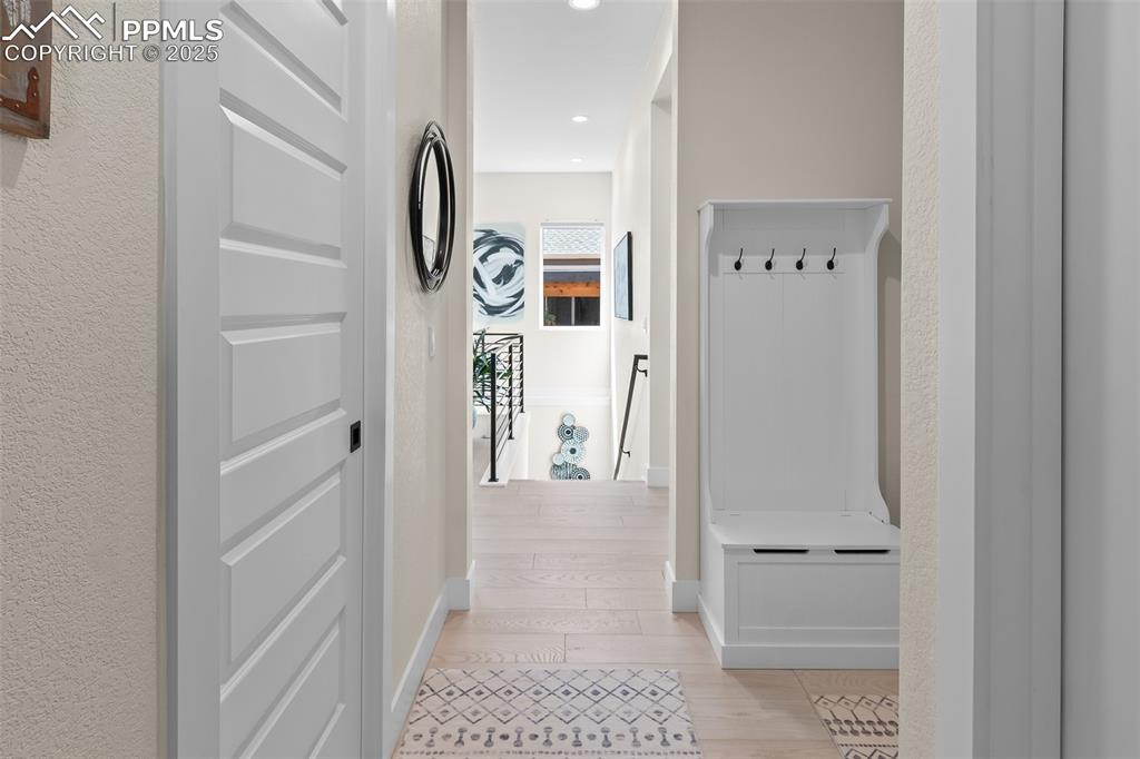 Image 29 of 48: Mudroom featuring light wood-style floors and recessed lighting