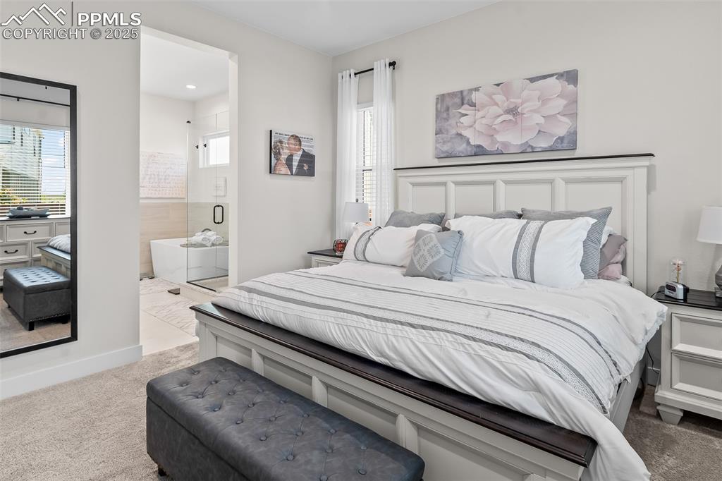 Image 32 of 48: Bedroom featuring carpet flooring and ensuite bathroom