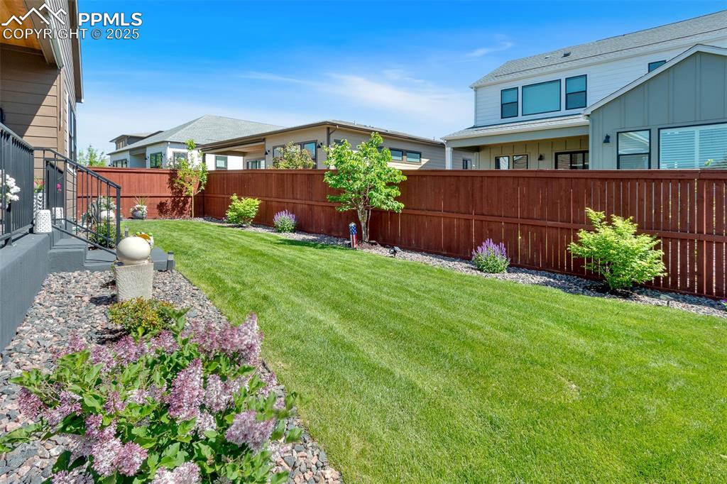 Image 5 of 48: View of fenced backyard