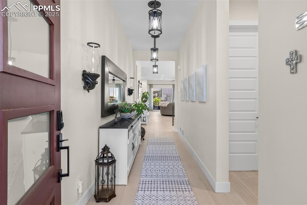 Image 8 of 48: Corridor featuring baseboards and light wood-style flooring