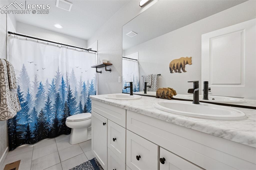 Image 23 of 39: Dual sinks in Hall Bathroom