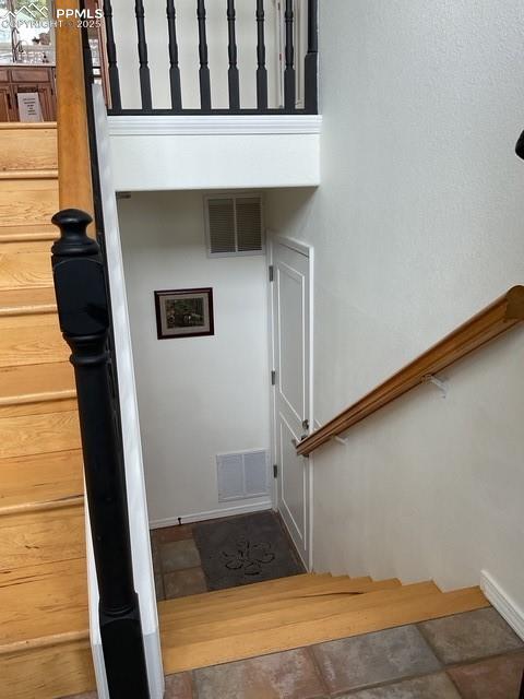 Image 15 of 39: Stairs to main level and Bi-level to garage entry
