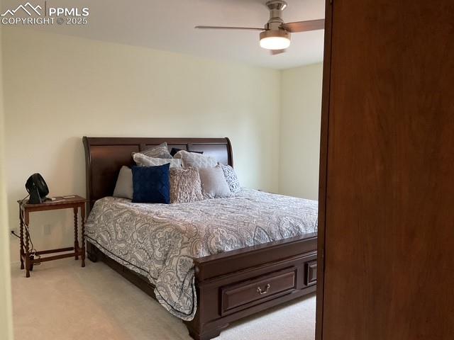 Image 29 of 39: Bedroom with light carpet and a ceiling fan