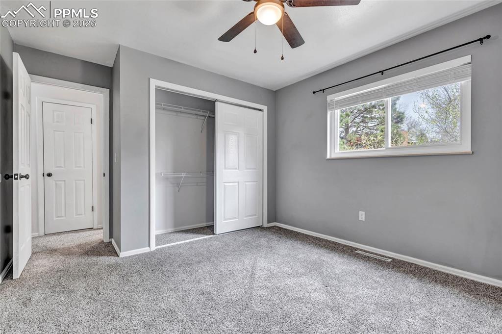 Image 18 of 31: Bedroom 2, Ceiling fan, carpet, updated window coverings