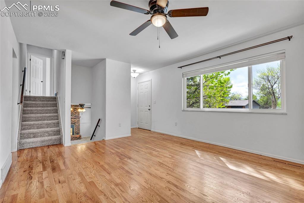 Image 3 of 31: Hardwood flooring, ceiling fan, updated window coverings