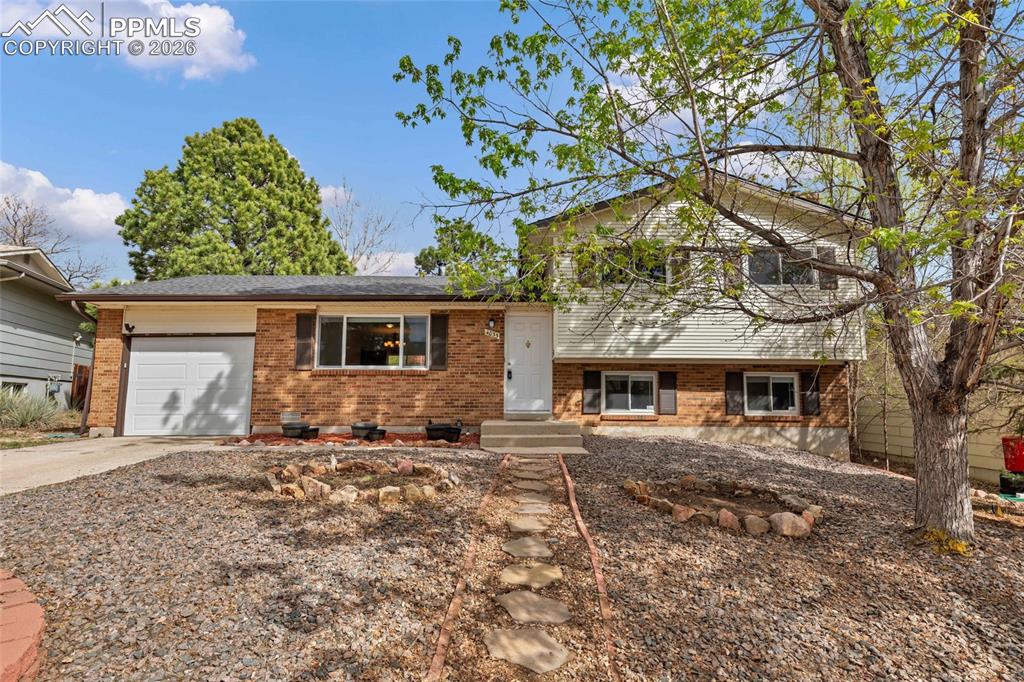 Image 7 of 31: Welcome home! Xeriscaped with flower beds