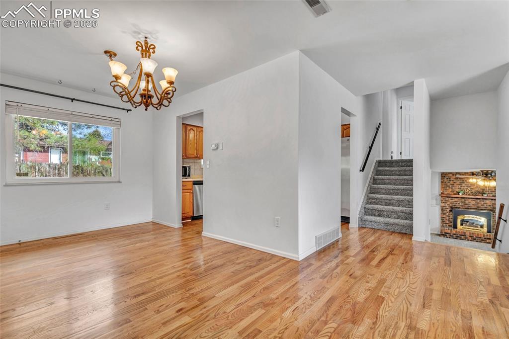 Image 9 of 31: Hardwood flooring, ceiling fan, updated window coverings