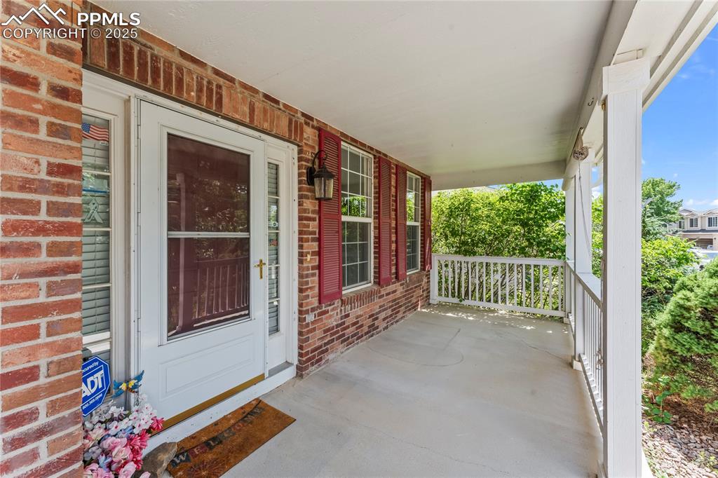 Image 13 of 49: Entrance to property featuring covered porch