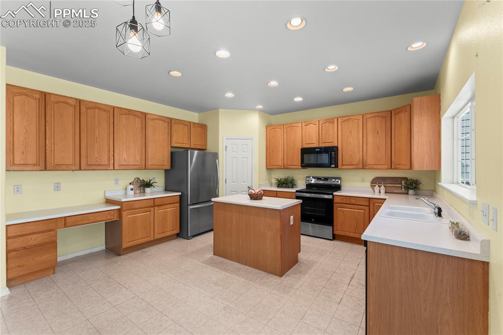 Image 17 of 49: Kitchen featuring appliances with stainless steel finishes, a kitchen islan