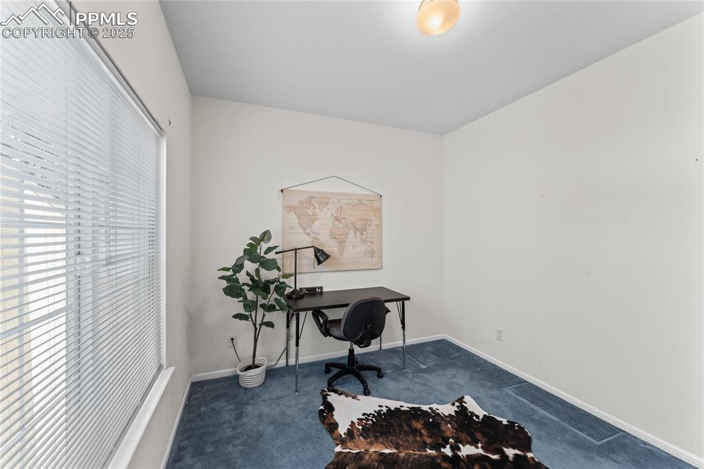 Image 23 of 49: Home office featuring carpet and baseboards