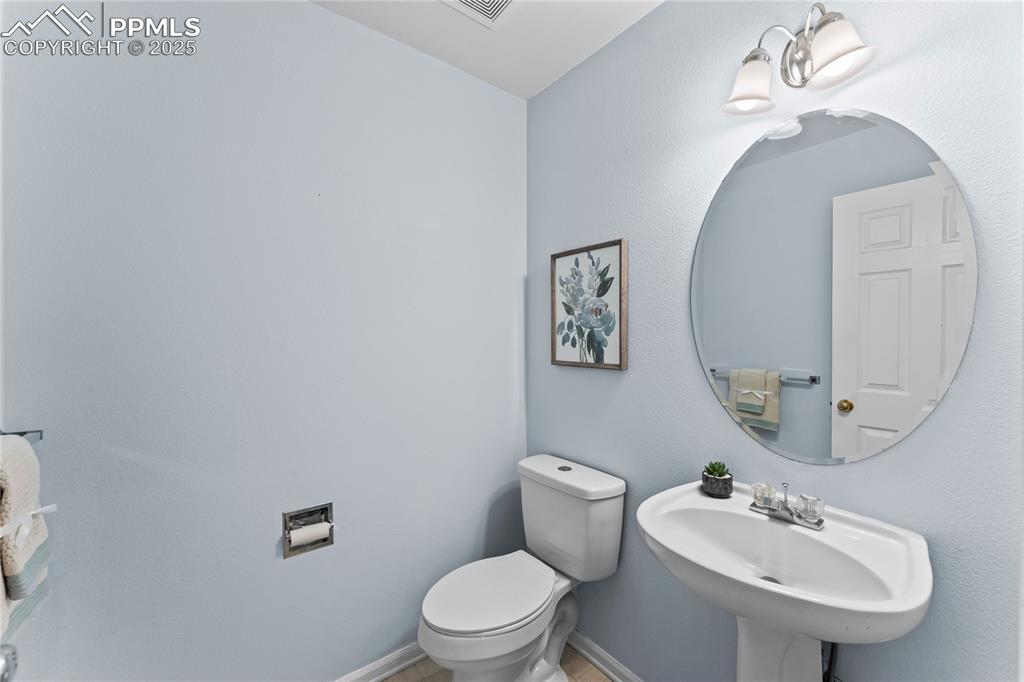 Image 24 of 49: Half bath with toilet and baseboards