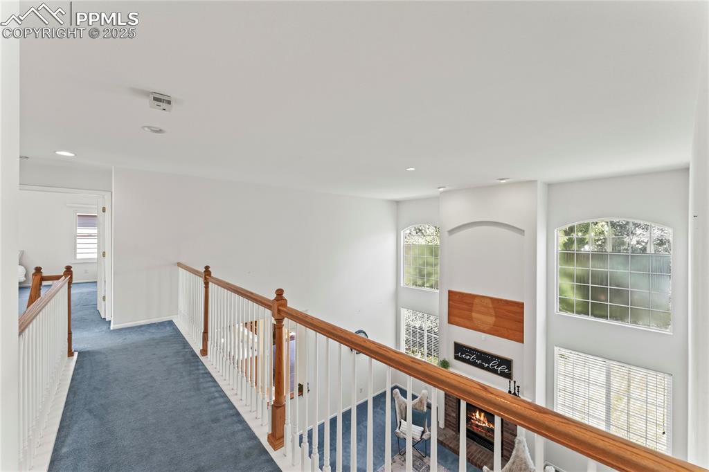 Image 25 of 49: Corridor with carpet, an upstairs landing, and recessed lighting