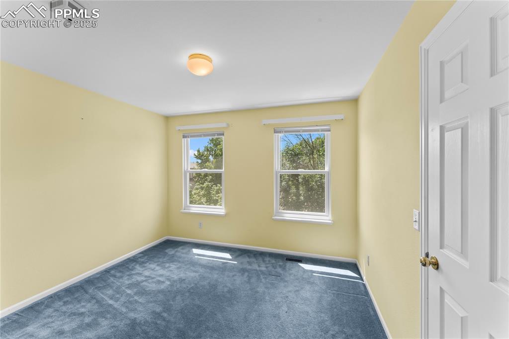 Image 27 of 49: Spare room featuring carpet floors and baseboards