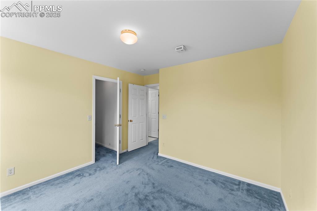 Image 28 of 49: Unfurnished bedroom with carpet and baseboards