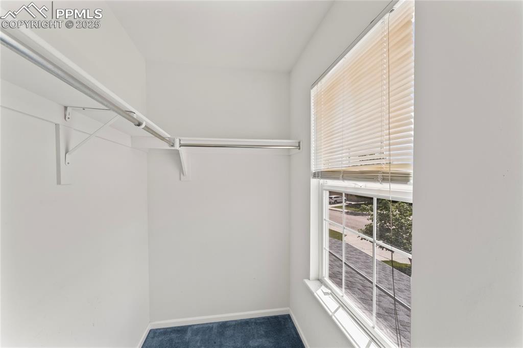 Image 32 of 49: Walk in closet with carpet