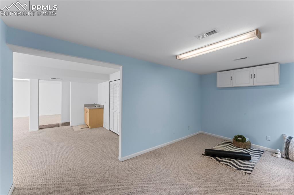 Image 44 of 49: Finished basement featuring light colored carpet