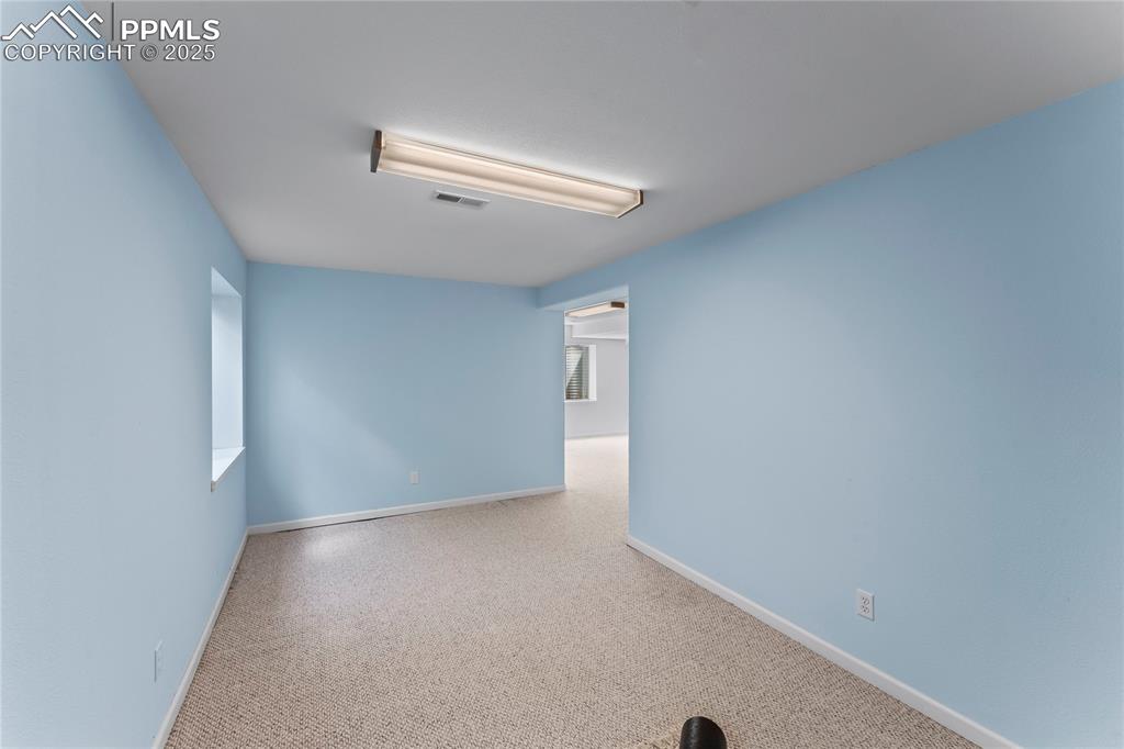 Image 45 of 49: Carpeted spare room with baseboards