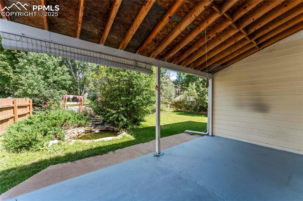 Image 46 of 49: Covered patio and pond