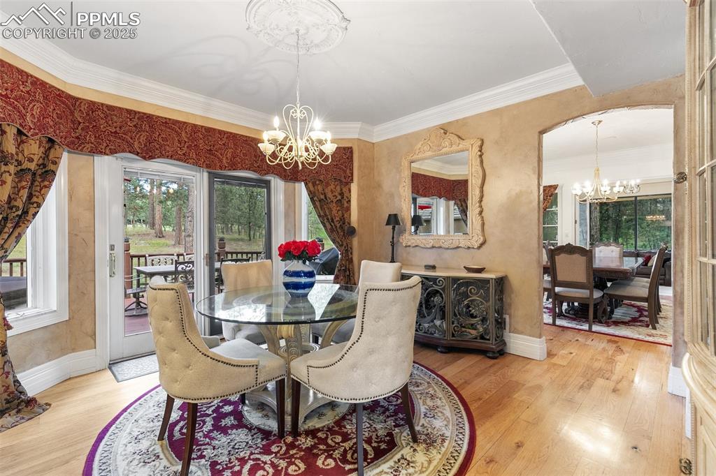 Image 10 of 50: Dining space featuring a chandelier, plenty of natural light, wood finished