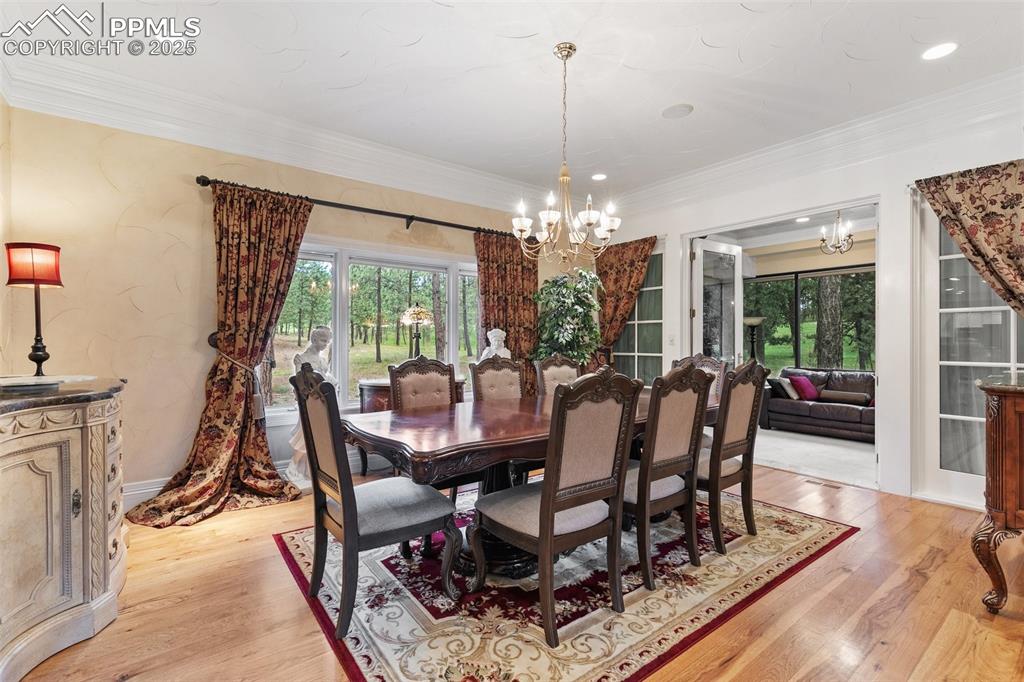 Image 16 of 50: Dining area featuring a chandelier, healthy amount of natural light, light 